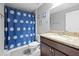 Bathroom features granite countertop, modern vanity, shower with a blue and white flower curtain at 60 Hemlock Trl, Ocala, FL 34472