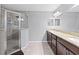 Bathroom with tile floors, glass shower, granite counters, and dual sinks at 60 Hemlock Trl, Ocala, FL 34472