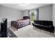 Cozy bedroom featuring a futon, carpet and a window with a view of the back yard at 60 Hemlock Trl, Ocala, FL 34472