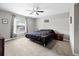 A neutrally decorated bedroom with a window, ceiling fan and a cozy feel at 60 Hemlock Trl, Ocala, FL 34472