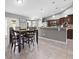 Spacious dining room area with decorative lighting and views into the kitchen at 60 Hemlock Trl, Ocala, FL 34472