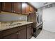 Laundry room featuring a laundry sink, granite countertops and cabinets at 60 Hemlock Trl, Ocala, FL 34472