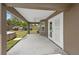 Covered back patio with dual French doors, a ceiling fan, and views of the backyard at 60 Hemlock Trl, Ocala, FL 34472