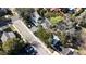 An aerial view shows a charming home with mature trees, a garage, and street access at 743 E Fort King St, Ocala, FL 34471