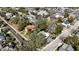 An aerial view shows a charming two-story home with mature trees and a defined property line at 743 E Fort King St, Ocala, FL 34471