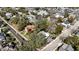 An aerial view shows a charming two-story home with mature trees and a defined property line at 743 E Fort King St, Ocala, FL 34471