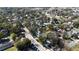 An aerial view shows a charming home amongst mature trees and neighborhood views at 743 E Fort King St, Ocala, FL 34471