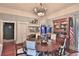 Traditional dining room with hardwood floors, round table, china cabinet, and decorative fireplace at 743 E Fort King St, Ocala, FL 34471