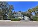 Charming yellow two-story home with a detached garage and well-maintained lawn at 743 E Fort King St, Ocala, FL 34471