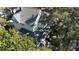 A bright home exterior features a detailed roof, a front porch, and is surrounded by mature trees at 743 E Fort King St, Ocala, FL 34471