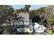 A bright home exterior features a detailed roof, second story porch, and two-car garage at 743 E Fort King St, Ocala, FL 34471