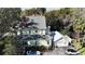 A bright home exterior features a detailed roof, second story porch, and two-car garage at 743 E Fort King St, Ocala, FL 34471