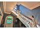 Grand foyer featuring staircase, stained glass window, chandelier, and detailed molding at 743 E Fort King St, Ocala, FL 34471
