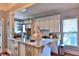 Bright kitchen featuring white cabinets, marble countertops, stainless appliances and an open serving counter at 743 E Fort King St, Ocala, FL 34471