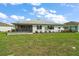 Expansive backyard with well-maintained lawn, a screened patio, and tastefully landscaped borders, ideal for outdoor enjoyment at 8457 Sw 97Th Cir, Ocala, FL 34481