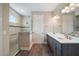Modern bathroom featuring a double vanity, step-in shower, dark wood floors, and a tiled shower at 8457 Sw 97Th Cir, Ocala, FL 34481