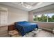 Bedroom with a cozy rug, wooden floors, tray ceiling and natural light from a large window at 8457 Sw 97Th Cir, Ocala, FL 34481