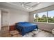 Serene bedroom with a cozy rug, wooden floors, tray ceiling and natural light from a large window at 8457 Sw 97Th Cir, Ocala, FL 34481