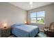 Cozy bedroom featuring a comfortable bed, a large window with neighborhood views, and ample natural light at 8457 Sw 97Th Cir, Ocala, FL 34481