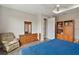 Bedroom displaying a traditional dresser, wooden bookshelf, and bed with a blue quilt at 8457 Sw 97Th Cir, Ocala, FL 34481