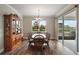 Dining room showcasing an ornate wooden cabinet and table, chandelier, and access to outdoor patio at 8457 Sw 97Th Cir, Ocala, FL 34481