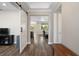 Elegant foyer with hardwood floors and a barn door feature at 8457 Sw 97Th Cir, Ocala, FL 34481