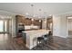 Modern kitchen with an island, stainless steel appliances, and dark wood cabinetry at 8457 Sw 97Th Cir, Ocala, FL 34481