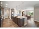 Open-concept kitchen with stainless steel appliances and a large center island at 8457 Sw 97Th Cir, Ocala, FL 34481