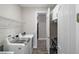 Well-equipped laundry room with modern washer and dryer, storage cabinets, and convenient access to the walk-in closet at 8457 Sw 97Th Cir, Ocala, FL 34481