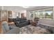 Inviting living room features a plush rug, comfortable seating, and large windows for natural light at 8457 Sw 97Th Cir, Ocala, FL 34481