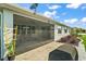 Inviting screened patio featuring comfortable seating, a barbecue grill, and views of the manicured backyard, perfect for relaxation at 8457 Sw 97Th Cir, Ocala, FL 34481