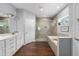 Bathroom with a double vanity, a walk-in shower, a soaking tub, and a dark wood look floor at 9940 Sw 45Th Ave, Ocala, FL 34476