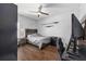 Bedroom featuring hardwood floors, closet, ceiling fan, and a double bed frame at 9940 Sw 45Th Ave, Ocala, FL 34476