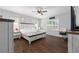 Spacious bedroom featuring hardwood floors, plantation shutters, and a ceiling fan at 9940 Sw 45Th Ave, Ocala, FL 34476