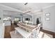 Bright dining area with modern chandelier, wainscoting, wood-look tile floors, and abundant natural light at 9940 Sw 45Th Ave, Ocala, FL 34476