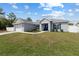Charming single-story home with a well-manicured lawn and blue accent shutters at 9940 Sw 45Th Ave, Ocala, FL 34476