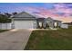 Charming single-story home featuring a two-car garage, manicured lawn, and inviting curb appeal at 9940 Sw 45Th Ave, Ocala, FL 34476