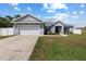 Charming single-story home featuring a two-car garage, manicured lawn, and inviting curb appeal at 9940 Sw 45Th Ave, Ocala, FL 34476