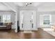 Inviting foyer with wood-look tile floors, natural light, and views to the dining and living areas at 9940 Sw 45Th Ave, Ocala, FL 34476