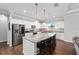 Bright kitchen with granite island, seating, stainless appliances, and hardwood floors at 9940 Sw 45Th Ave, Ocala, FL 34476