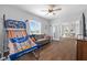 Comfortable living room with hardwood floors, ceiling fan, and view to the dining area at 9940 Sw 45Th Ave, Ocala, FL 34476