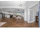 Open-concept living room with tray ceilings, wood-look tile floors, and access to the kitchen at 9940 Sw 45Th Ave, Ocala, FL 34476