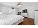 Spacious main bedroom with light gray walls, wood floors, shutters, a ceiling fan and a matching white dresser at 9940 Sw 45Th Ave, Ocala, FL 34476