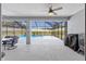A covered patio provides an outdoor living space, with outdoor seating, a grill, and views of the screened pool at 9940 Sw 45Th Ave, Ocala, FL 34476