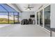 Cozy covered patio is ideal for outdoor entertaining, with a TV and barbecue area, accessible through sliding glass doors at 9940 Sw 45Th Ave, Ocala, FL 34476