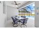 The covered lanai seating area offers a relaxing space with a glass table, chairs and a view of the screened-in pool at 9940 Sw 45Th Ave, Ocala, FL 34476