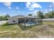 Backyard with a screened-in pool, lush green grass, and white fencing at 9940 Sw 45Th Ave, Ocala, FL 34476