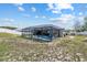 View of the screened-in pool and lanai area surrounded by a fenced in yard at 9940 Sw 45Th Ave, Ocala, FL 34476