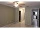 Bright bedroom with a ceiling fan, closet, and doorway leading to kitchen at 10843 Sw 91St Ter, Ocala, FL 34481