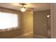 Neutral bedroom featuring a ceiling fan, bright natural light, and neutral color laminate flooring at 10843 Sw 91St Ter, Ocala, FL 34481
